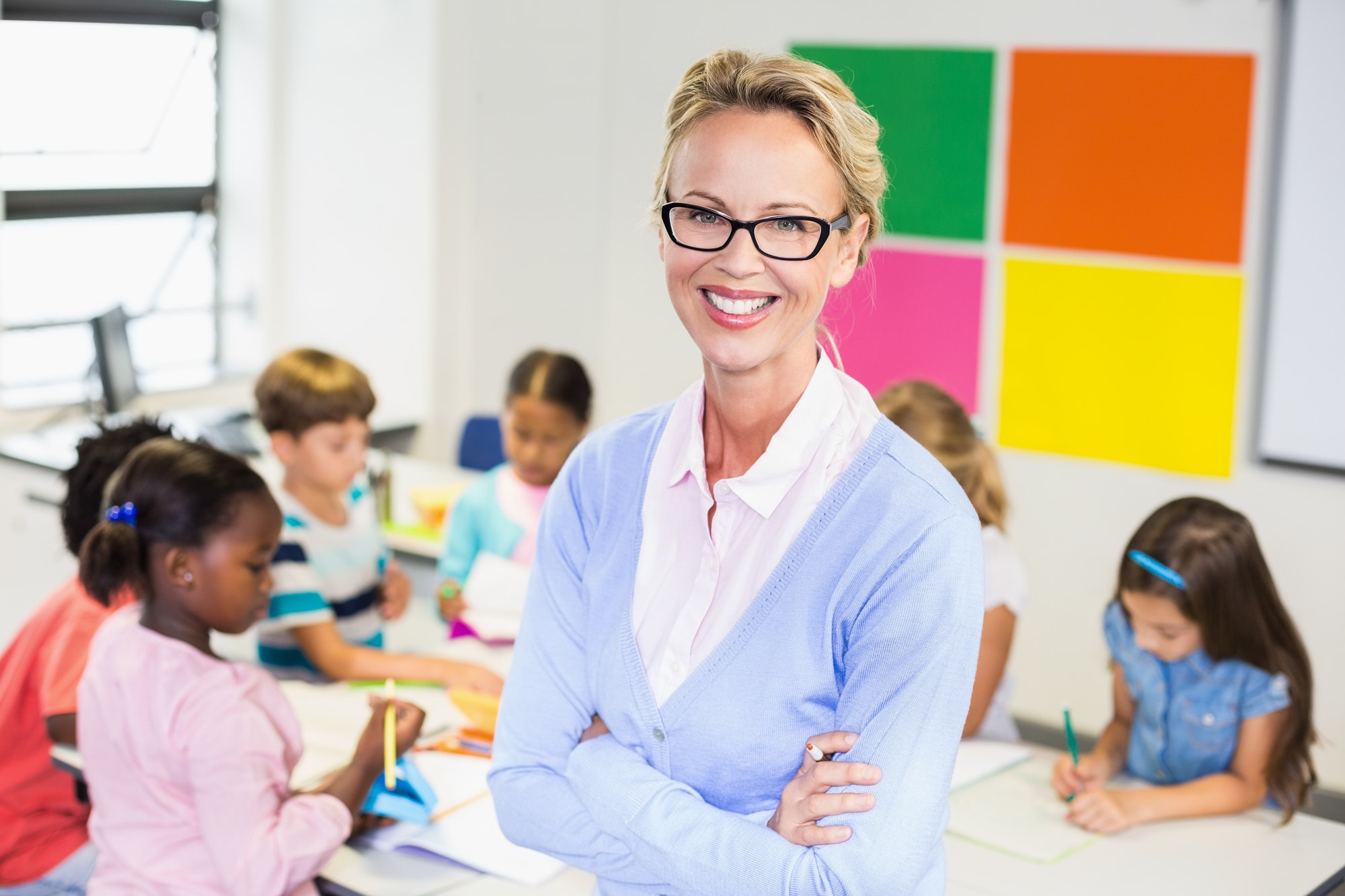 portrait-of-teacher-standing-in-classroom.jpg